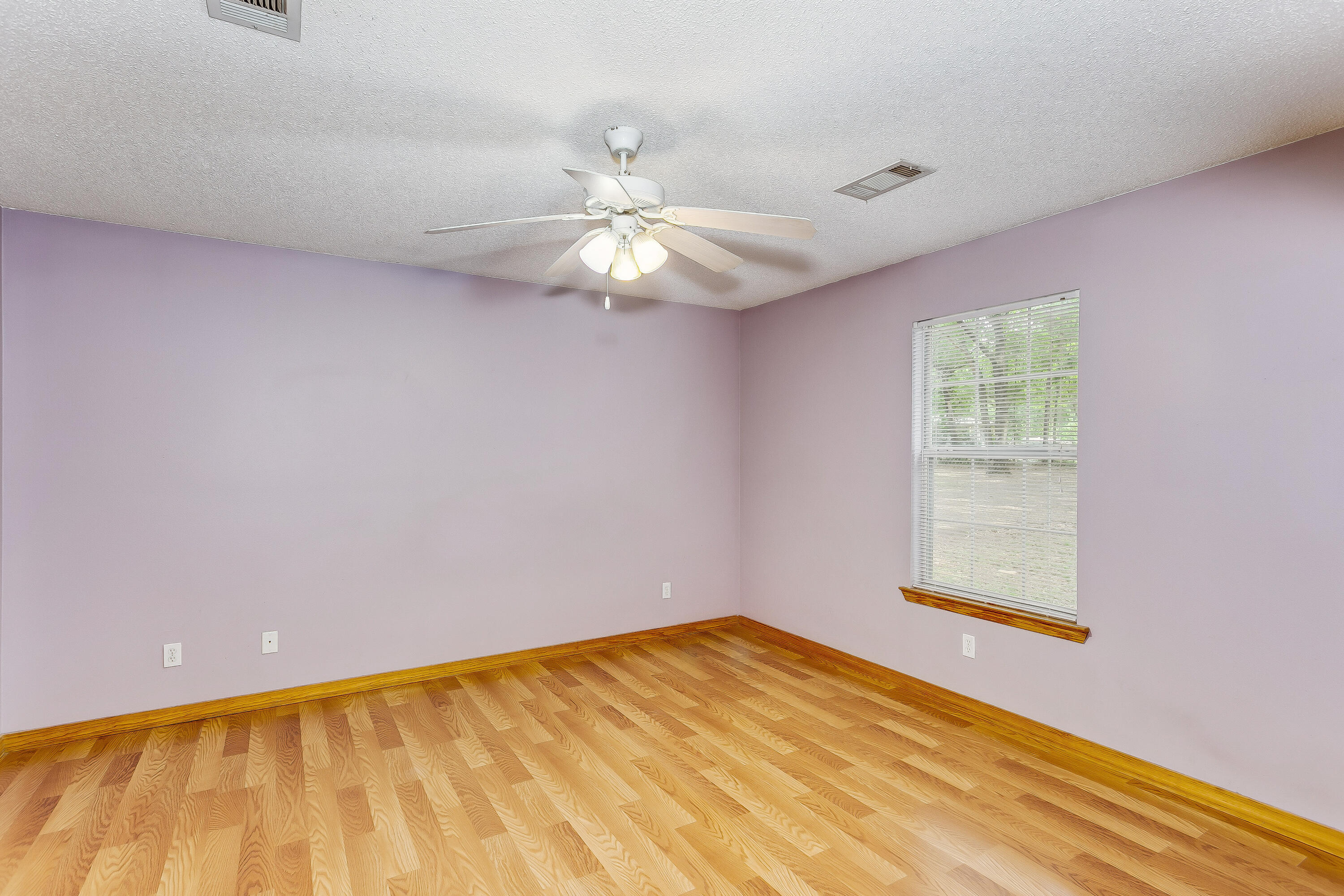 5360 Windham Road Milton, FL 32570 - Photo 11 of 27 wooden floor in an empty room with a window