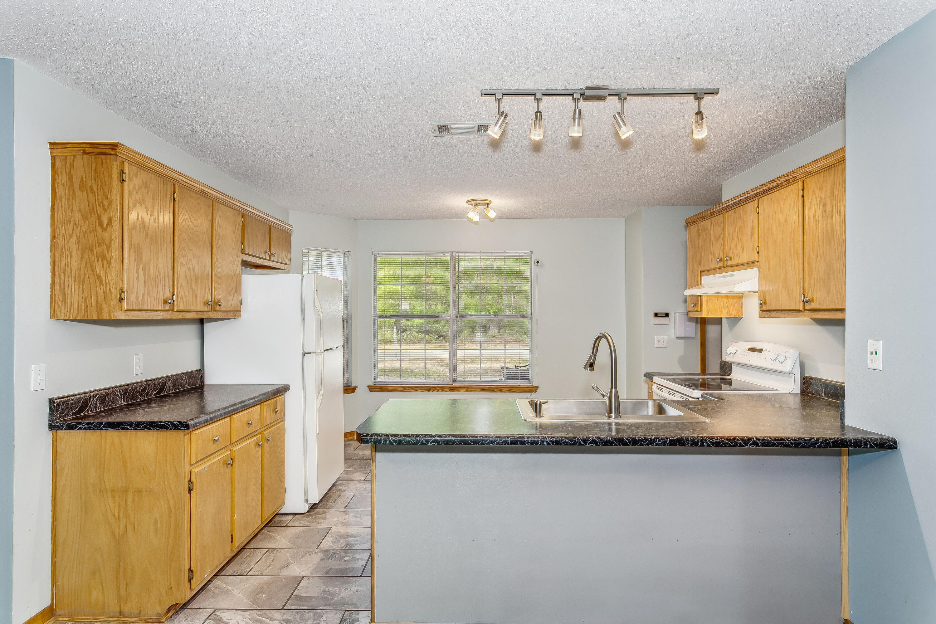 5360 Windham Road Milton, FL 32570 - Photo 8 of 27 a kitchen with granite countertop a sink and a counter top space