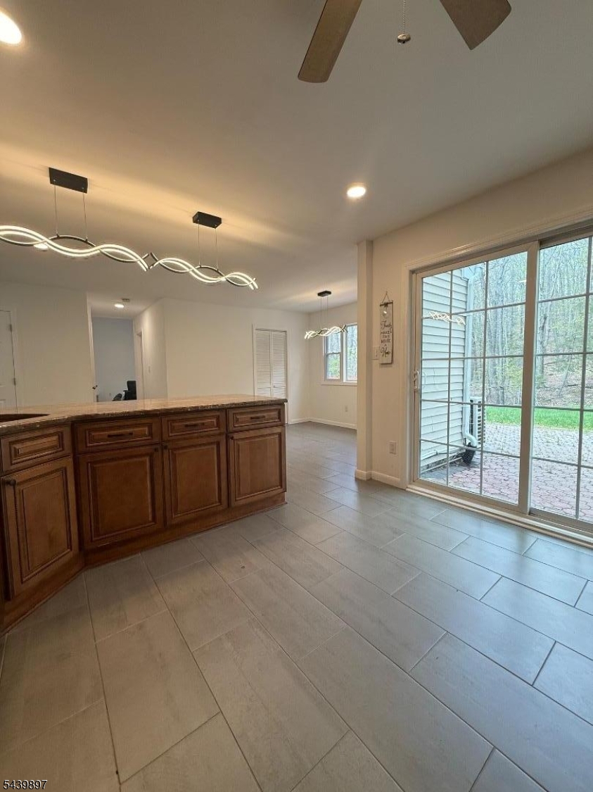 22 Karen Road Vernon, NJ 07422 - Photo 11 of 26 a large room with a large window and chandelier fan