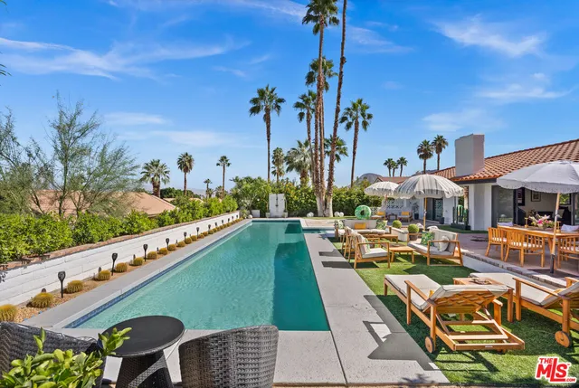 a view of swimming pool outdoor seating and city view