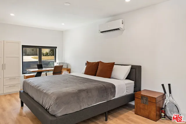 a bedroom with a bed and dresser