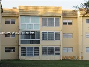 a front view of a building with a garden