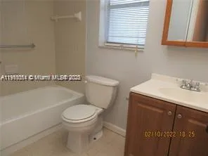 a bathroom with a toilet a sink and bathtub