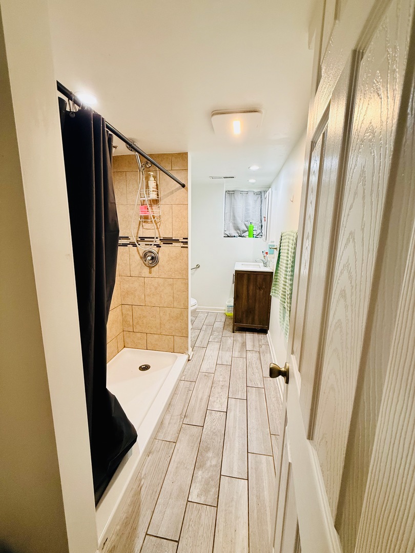 5542 South Nottingham Avenue Chicago, IL 60638 - Photo 38 of 39 a bathroom with a bathtub and a shower