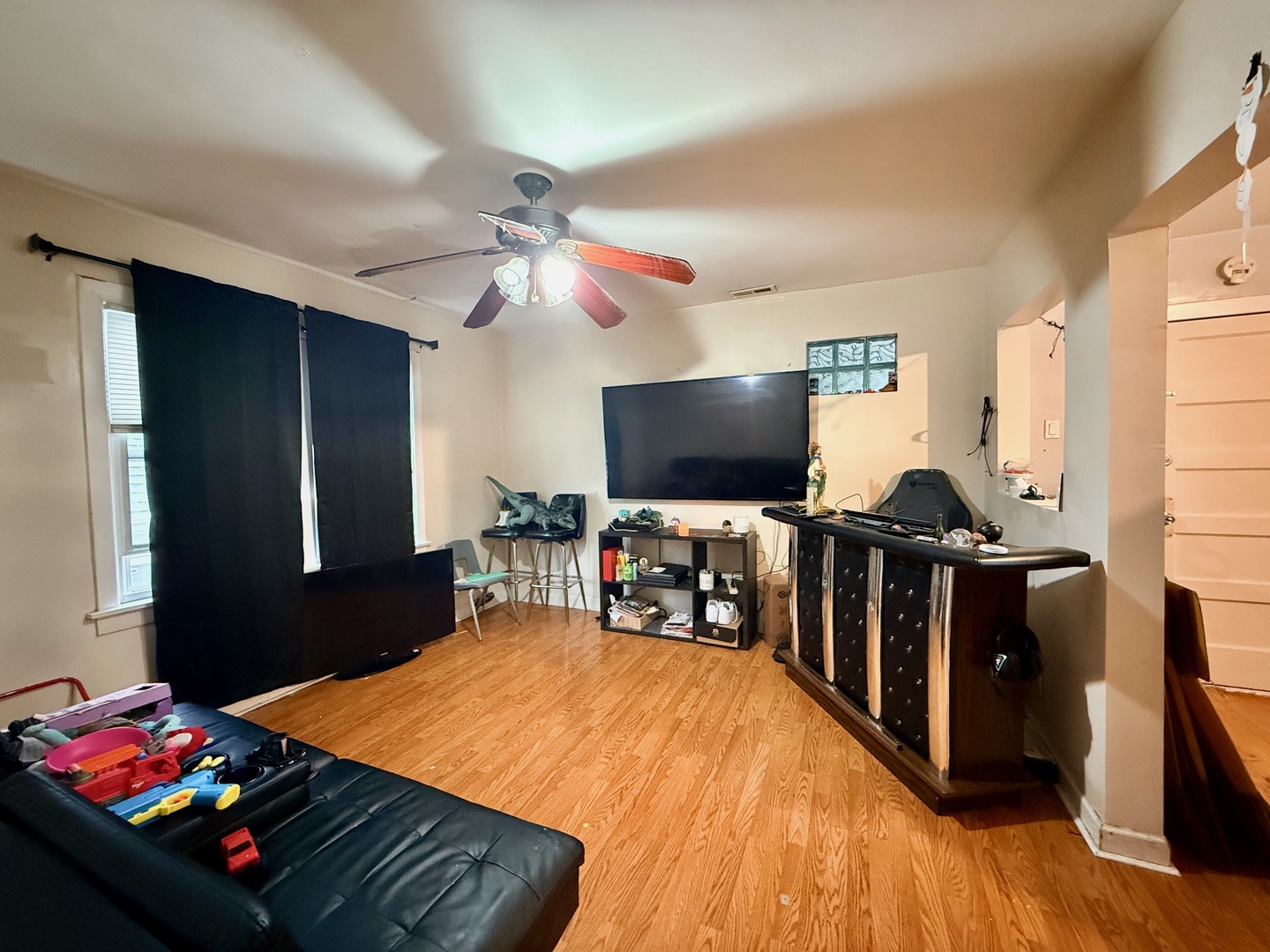 5542 South Nottingham Avenue Chicago, IL 60638 - Photo 7 of 39 a room with furniture and a flat screen tv
