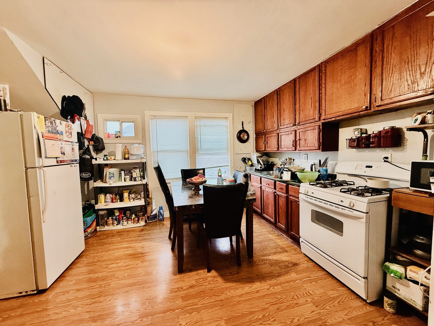5542 South Nottingham Avenue Chicago, IL 60638 - Photo 8 of 39 a kitchen with stainless steel appliances granite countertop a refrigerator a stove top oven a sink dishwasher and white cabinets with wooden floor