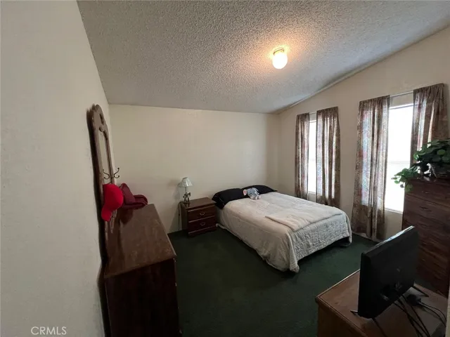 a bedroom with a bed and a potted plant