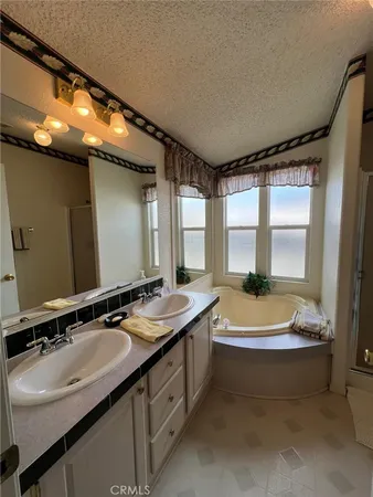a bathroom with a double vanity sink and a mirror