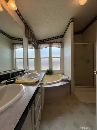 a bathroom with a granite countertop sink and a bathtub