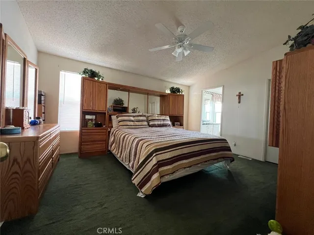 a bedroom with a bed wooden floor and lamp