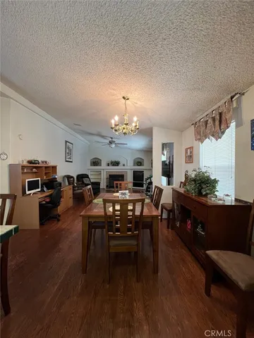 a living room with furniture a dining table and a fireplace