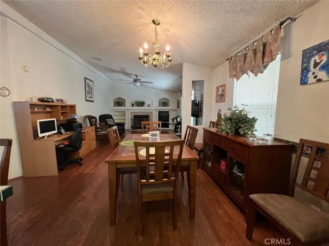 a living room with furniture kitchen view and a chandelier