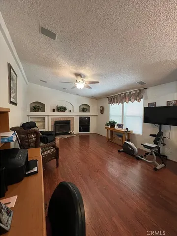 a living room with furniture a counter top space and a wooden floor