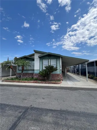 a front view of house with a garden