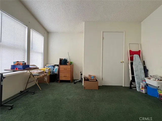 a view of a room with gym equipment and a window