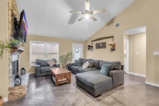 a living room with furniture a large window and a flat screen tv