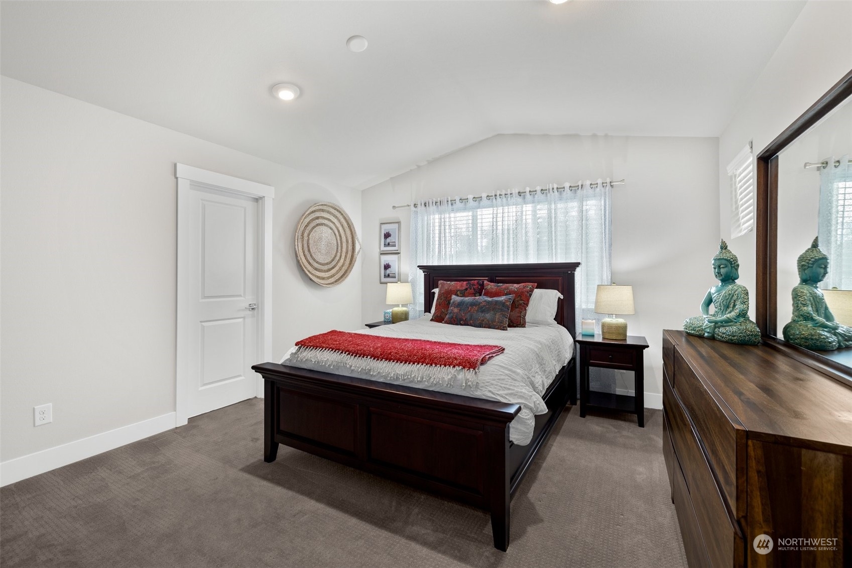 19732 Meridian Place West Bothell, WA 98012 - Photo 11 of 20 a bedroom with a bed and a chandelier