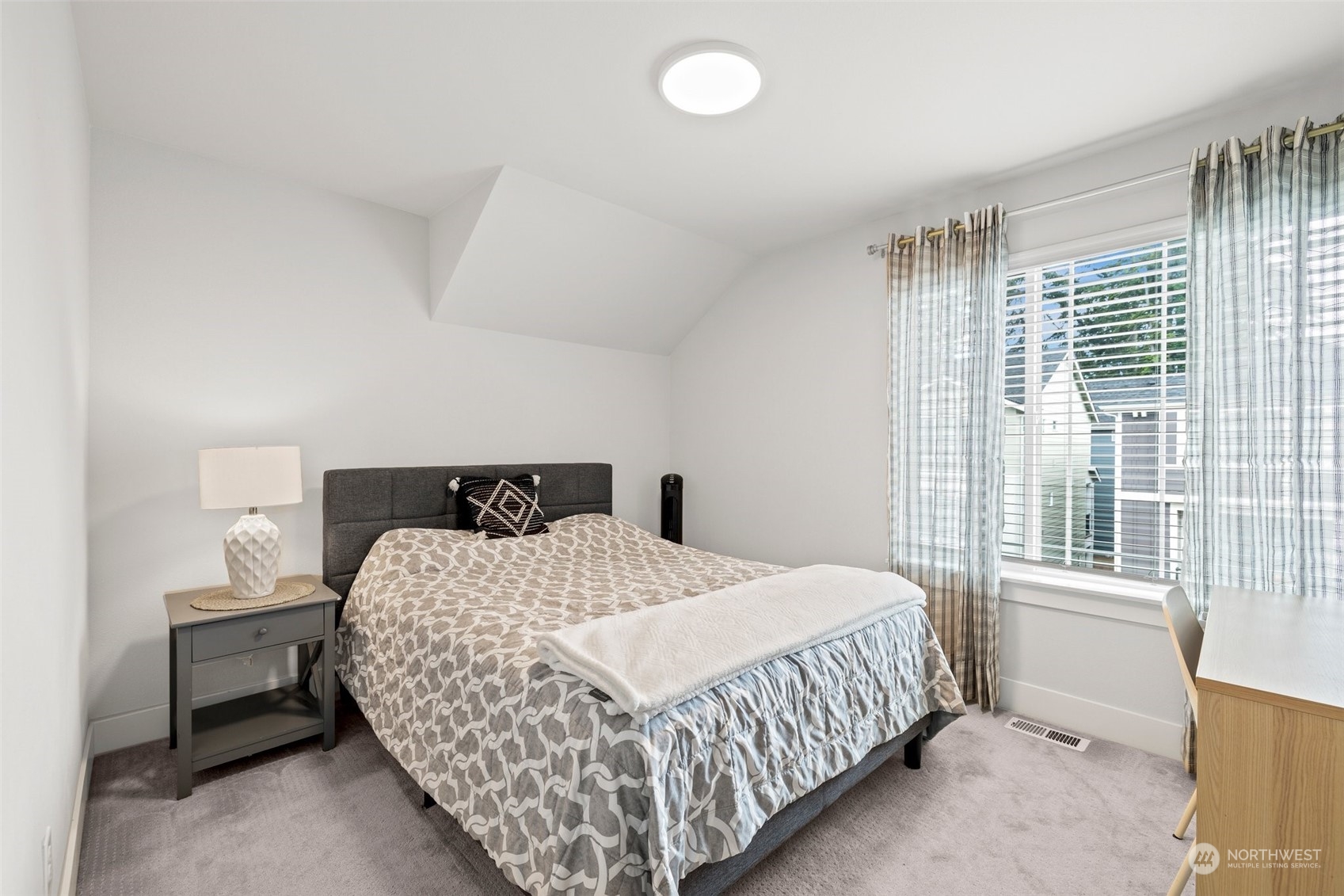 19732 Meridian Place West Bothell, WA 98012 - Photo 15 of 20 a bedroom with a bed and a window