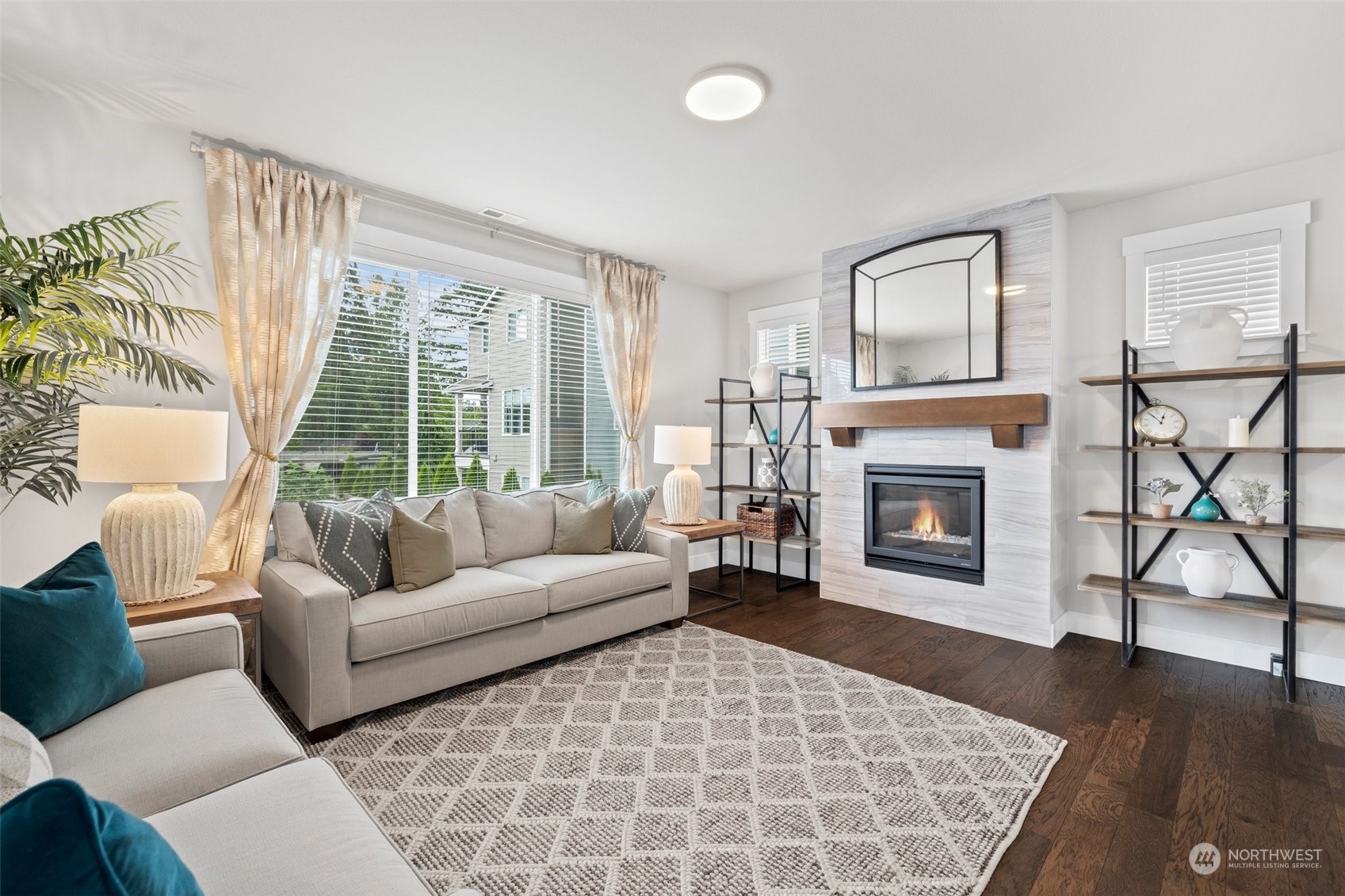 19732 Meridian Place West Bothell, WA 98012 - Photo 3 of 20 a living room with a couch a rug and a fireplace