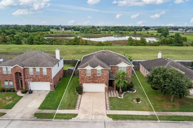 an aerial view of a house with big yard