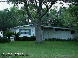 6951 Rollo Road Jacksonville, FL 32205 - Photo 1 of 1 a view of a garden with potted plants and large trees