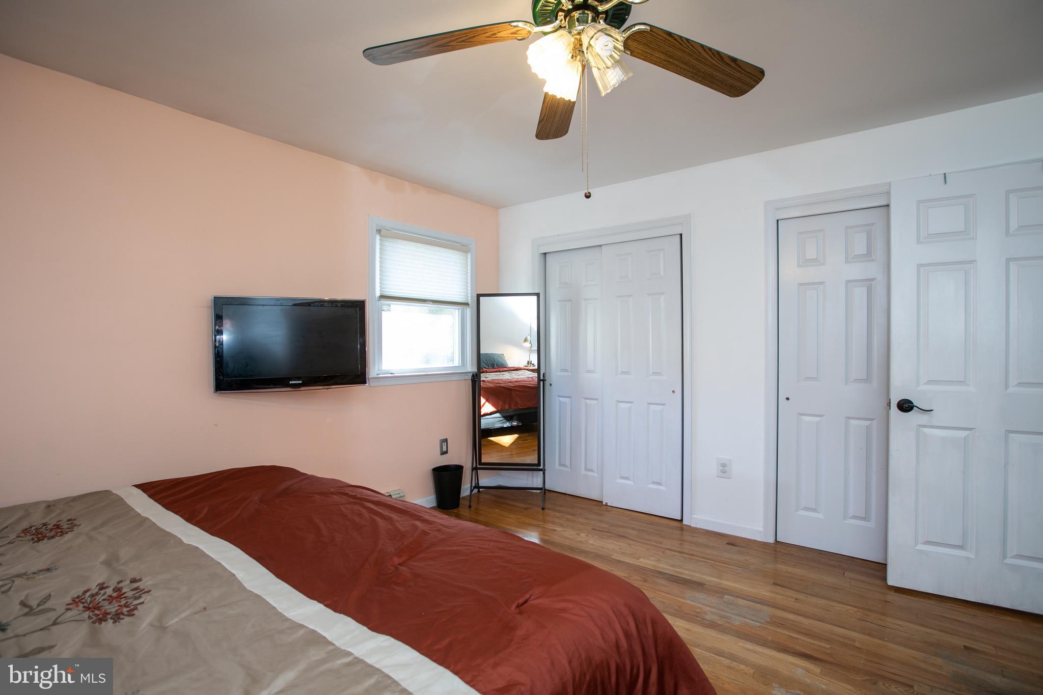 2112 Klockner Road Hamilton, NJ 08690 - Photo 22 of 40 a bedroom with a bed and a flat screen tv