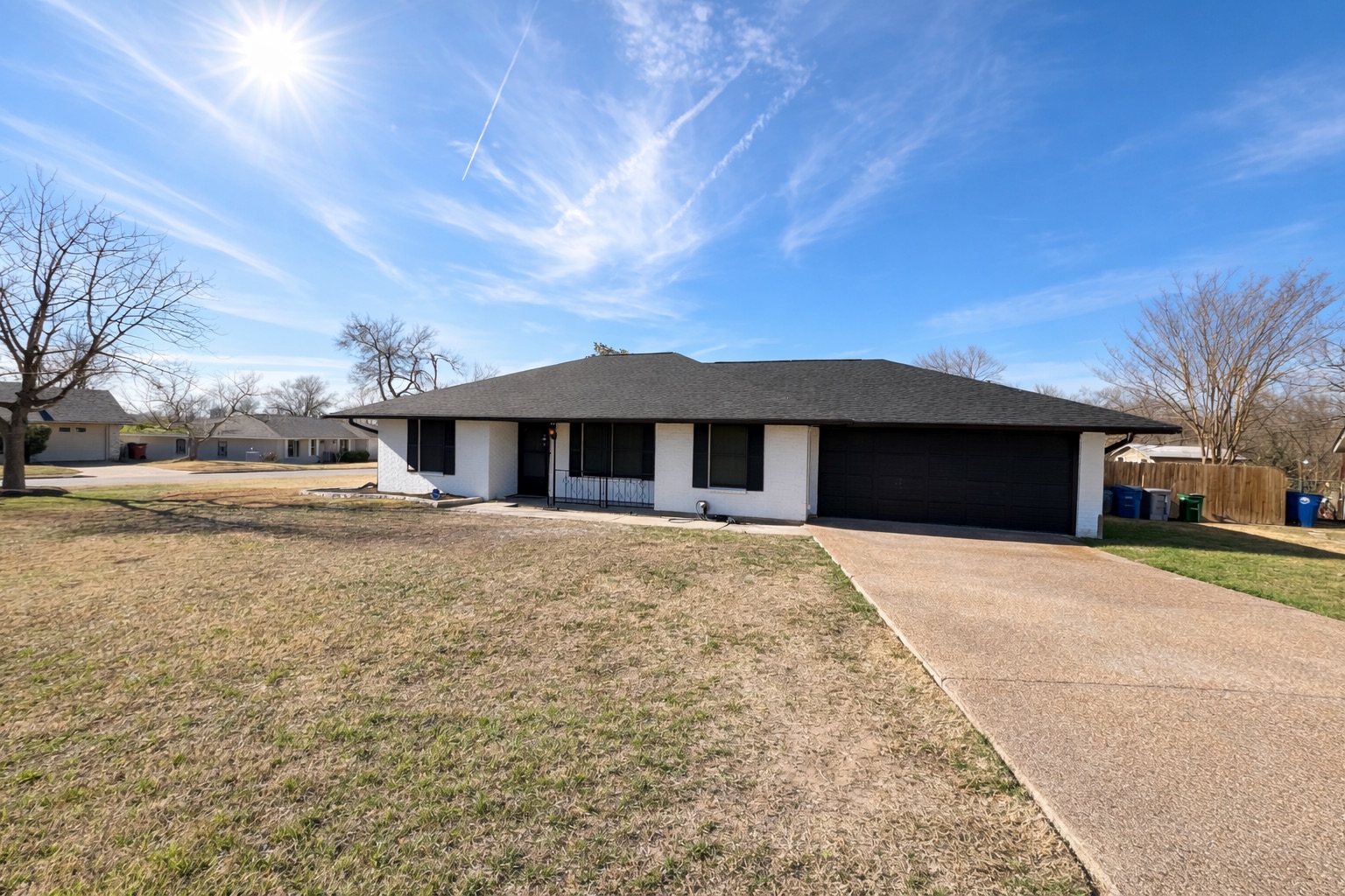 4500 Woodmoor Circle Austin, TX 78721 - Photo 1 of 6 Ranch-style home with driveway, a garage, roof with shingles, and covered porch
