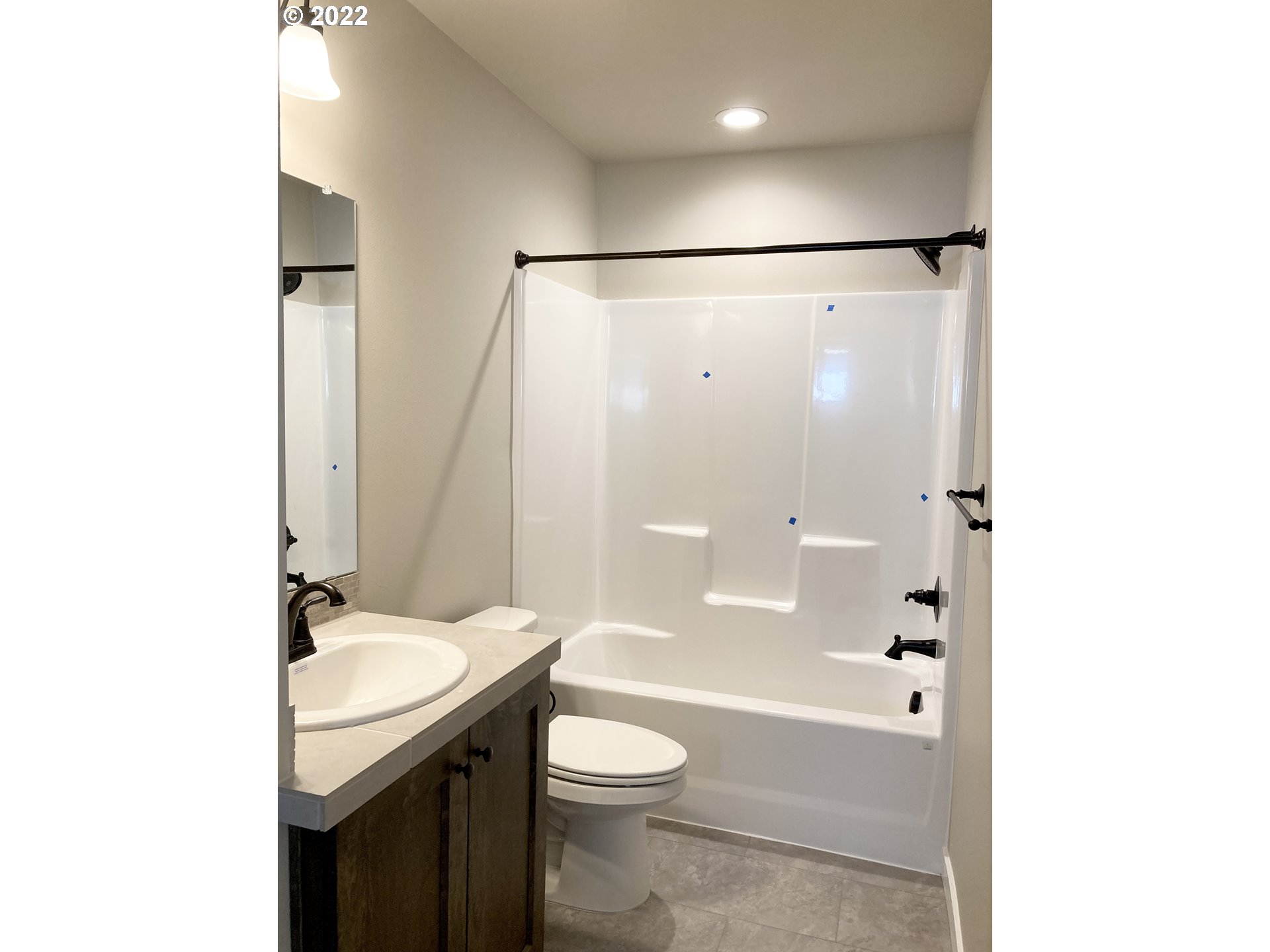 7250 South Ridge Way Ridgefield, WA 98642 - Photo 8 of 16 a bathroom with a granite countertop sink toilet and shower