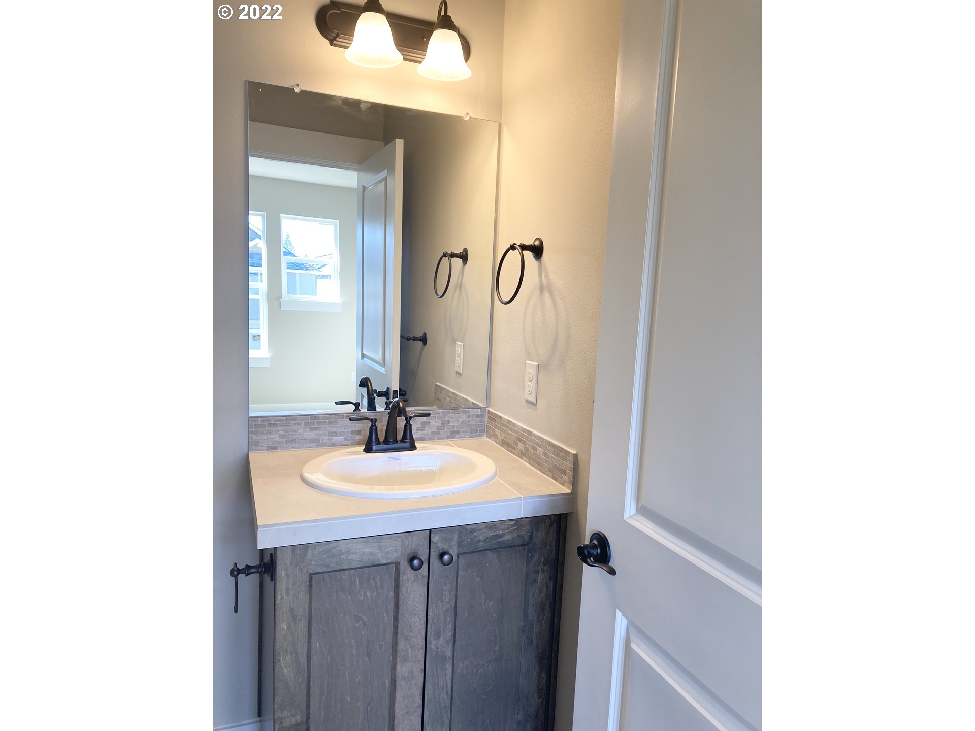 7250 South Ridge Way Ridgefield, WA 98642 - Photo 10 of 16 a bathroom with a sink and a mirror