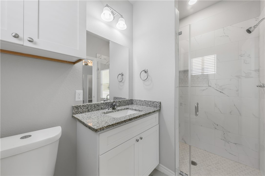 1805 Pin Oak Street Bryan, TX 77803 - Photo 5 of 20 Full bathroom with a shower stall and vanity