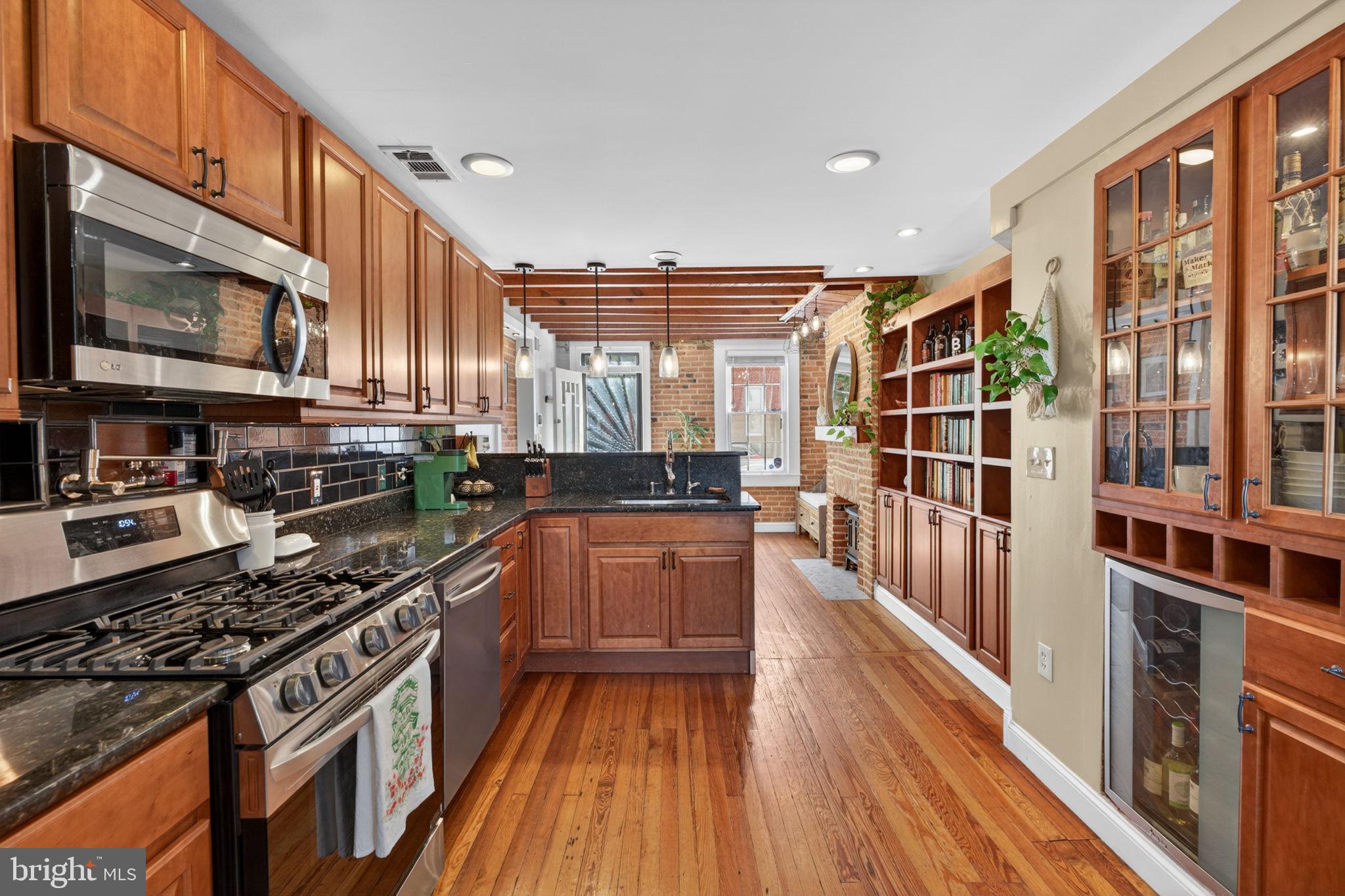 18 South Washington Street Baltimore, MD 21231 - Photo 12 of 57 a kitchen with stainless steel appliances a stove a sink and a refrigerator