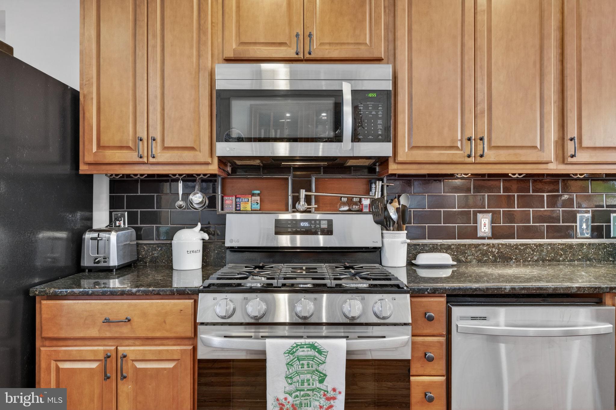 18 South Washington Street Baltimore, MD 21231 - Photo 15 of 57 a kitchen with granite countertop a stove and a sink