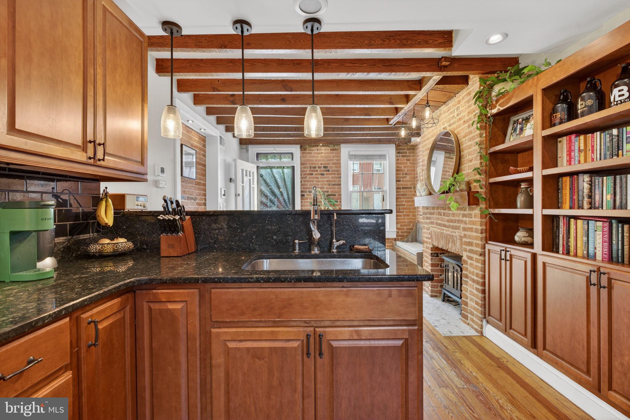 18 South Washington Street Baltimore, MD 21231 - Photo 16 of 57 a kitchen with stainless steel appliances granite countertop a sink and cabinets