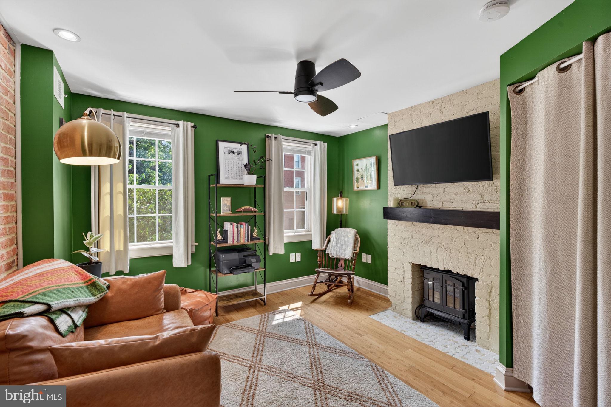 18 South Washington Street Baltimore, MD 21231 - Photo 27 of 57 a living room with furniture and a fireplace
