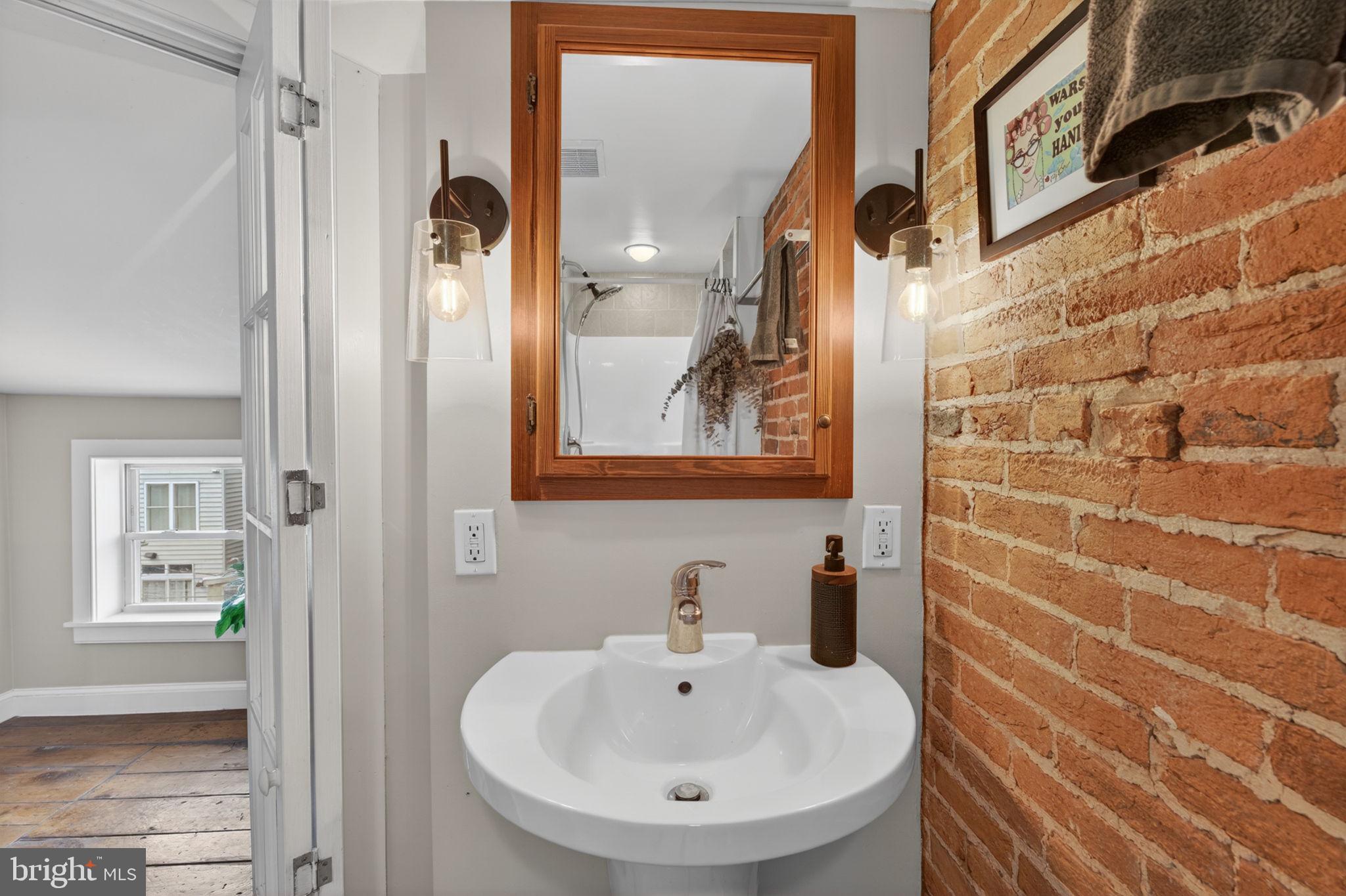 18 South Washington Street Baltimore, MD 21231 - Photo 38 of 57 a bathroom with a sink and a mirror