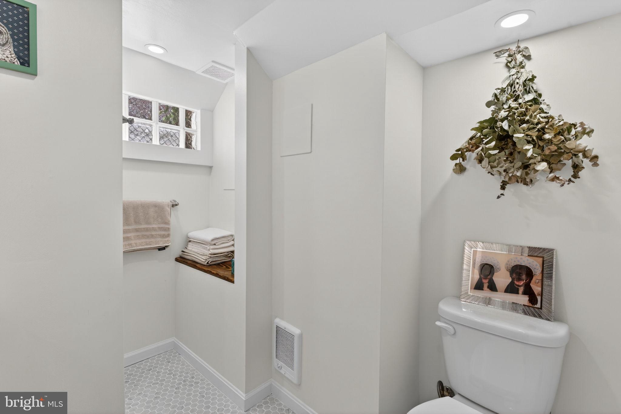 18 South Washington Street Baltimore, MD 21231 - Photo 43 of 57 a bathroom with a toilet and a shower curtain