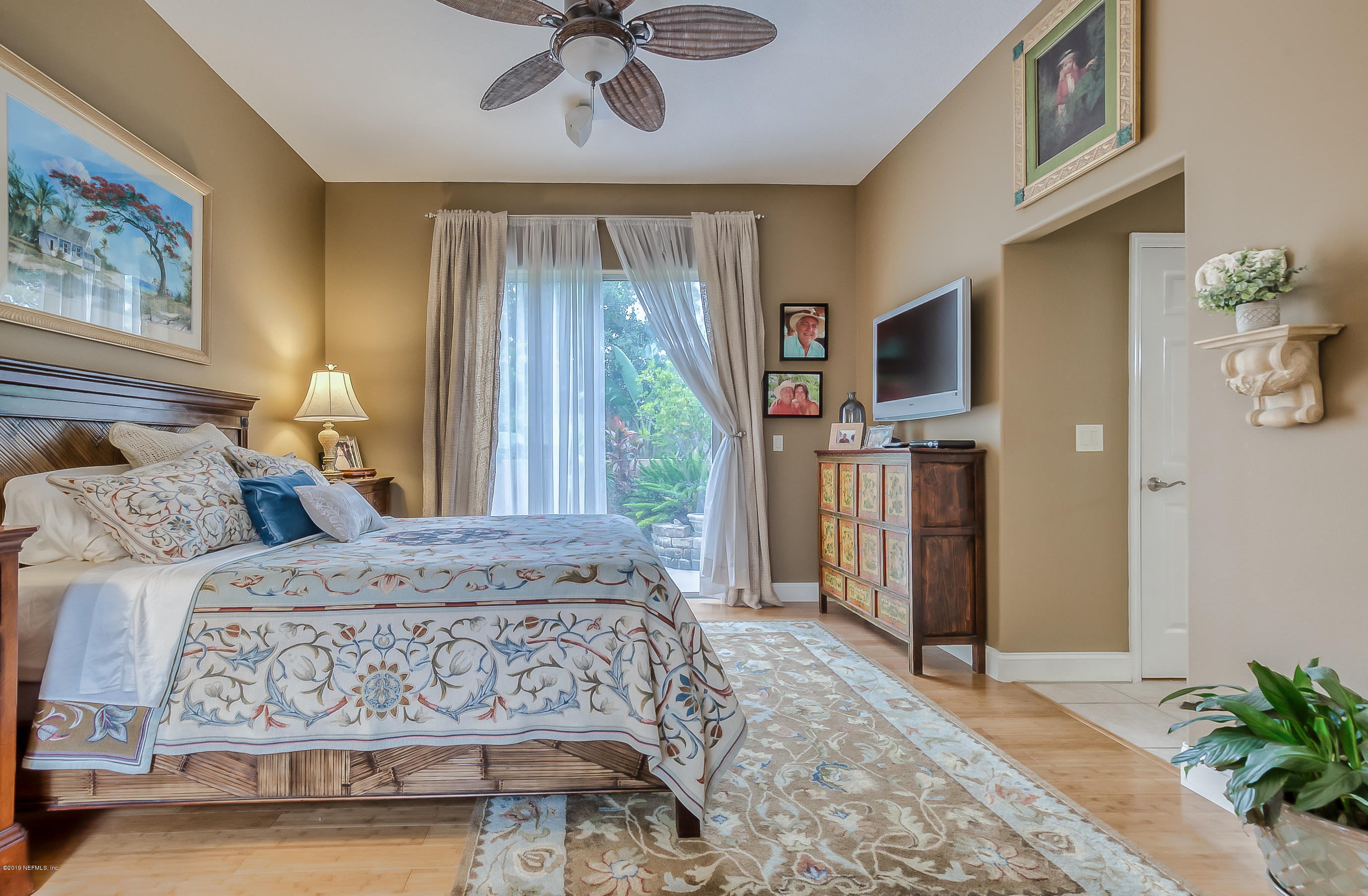 200 Cedar Ridge Circle St. Augustine, FL 32080 - Photo 16 of 41 a bedroom with a bed wooden floor and flat screen tv
