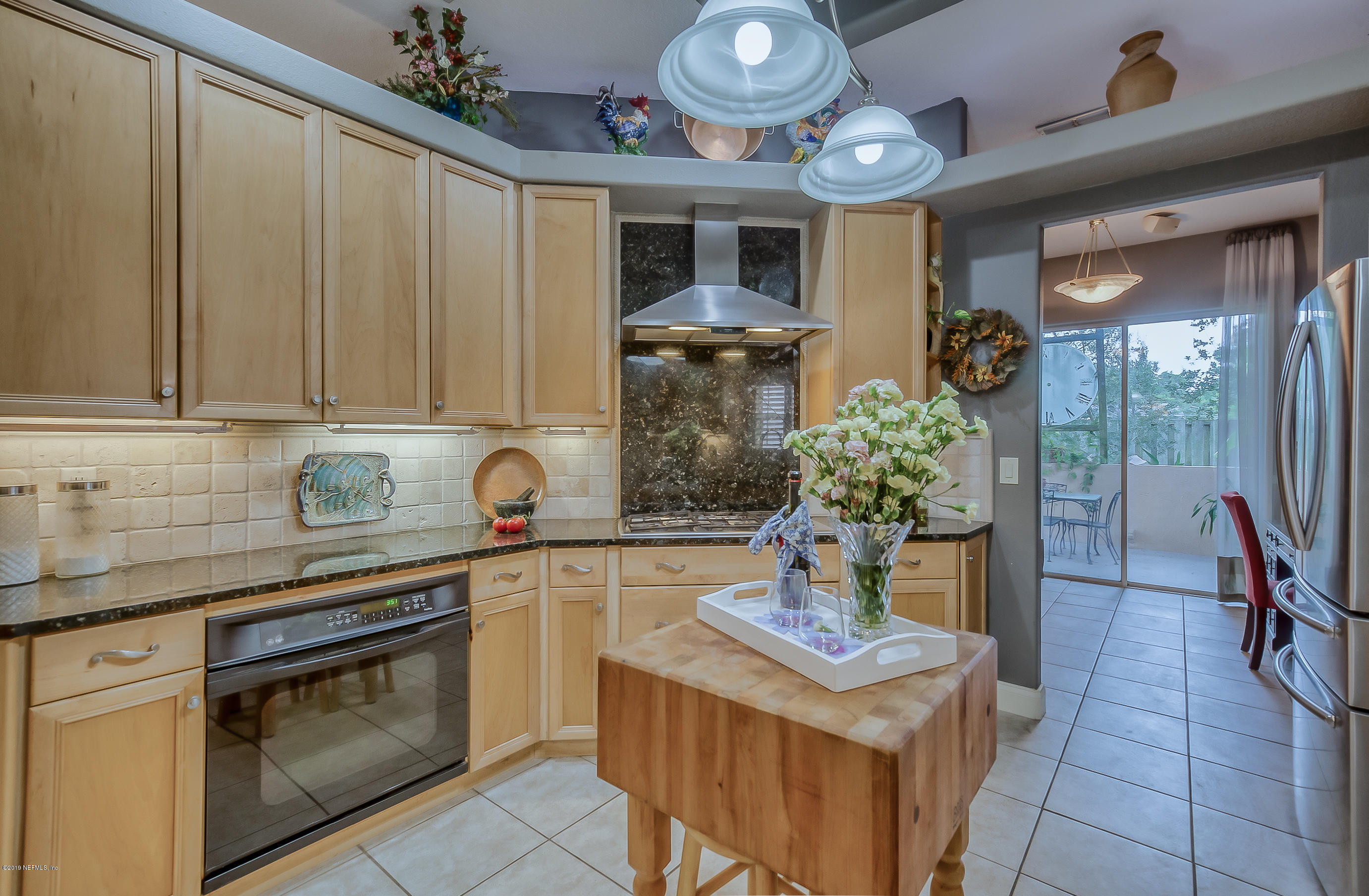 200 Cedar Ridge Circle St. Augustine, FL 32080 - Photo 22 of 41 a kitchen with stainless steel appliances granite countertop a stove a sink and a microwave