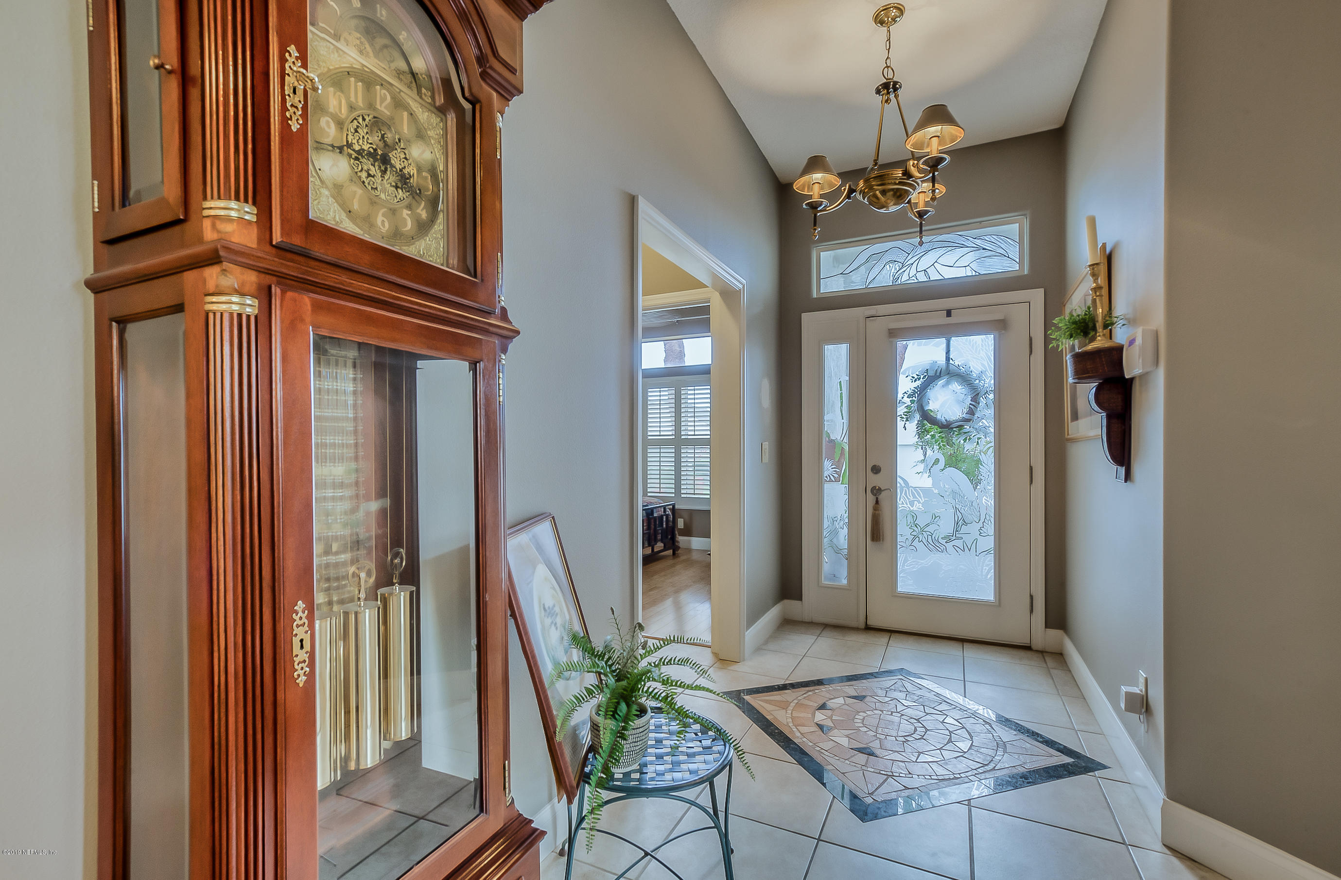 200 Cedar Ridge Circle St. Augustine, FL 32080 - Photo 3 of 41 a view of an entryway with a flower pot and a bookshelf
