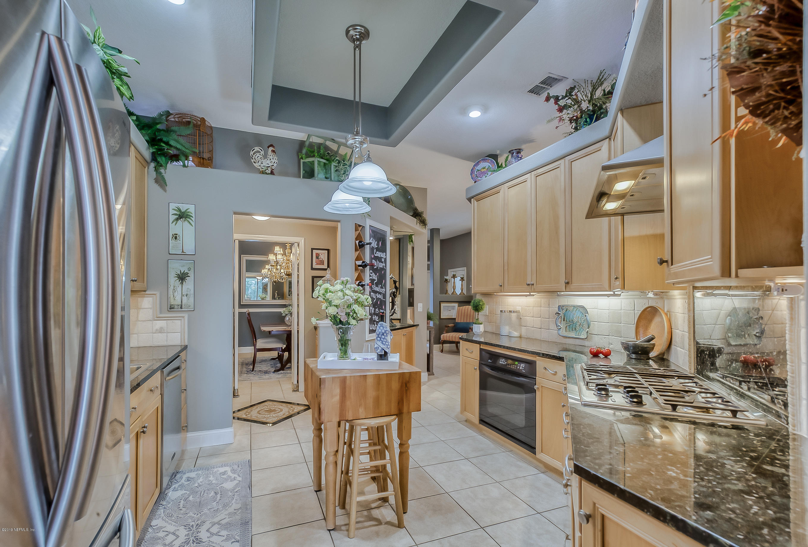 200 Cedar Ridge Circle St. Augustine, FL 32080 - Photo 10 of 41 a kitchen with stainless steel appliances granite countertop a refrigerator a sink a stove and white cabinets