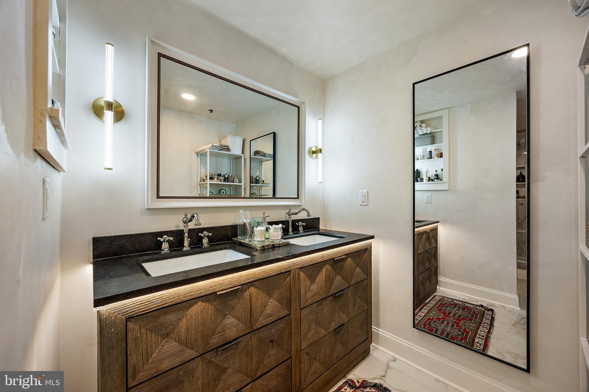 49 Bancroft Mills Road, Unit 2B Wilmington, DE 19806 - Photo 13 of 18 a bathroom with a sink and a mirror