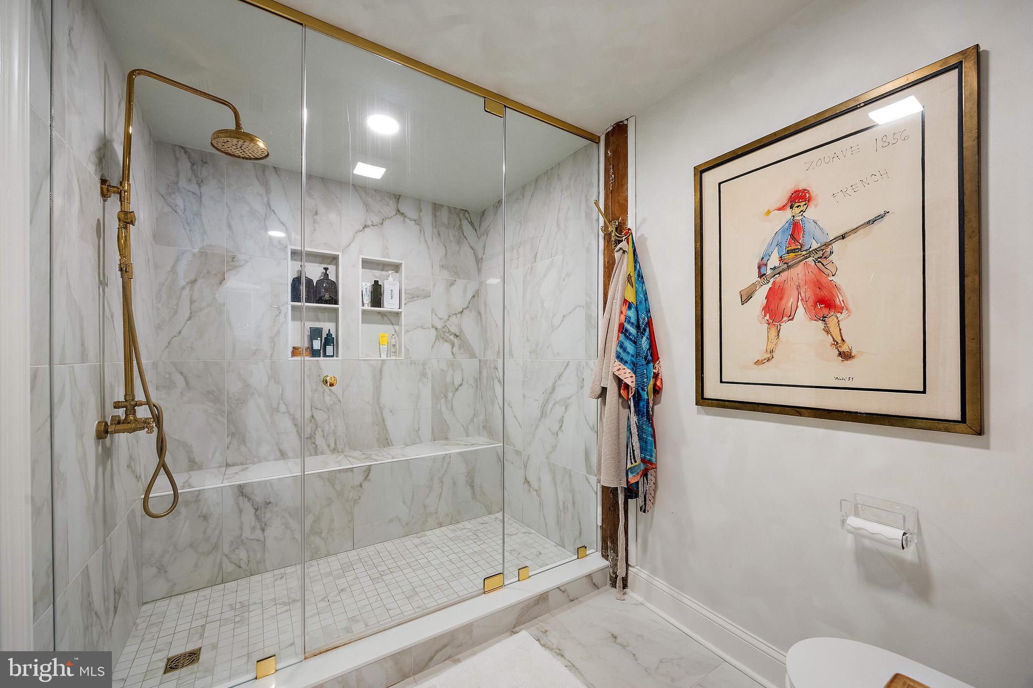 49 Bancroft Mills Road, Unit 2B Wilmington, DE 19806 - Photo 14 of 18 a bathroom with a painting on the wall and a shower