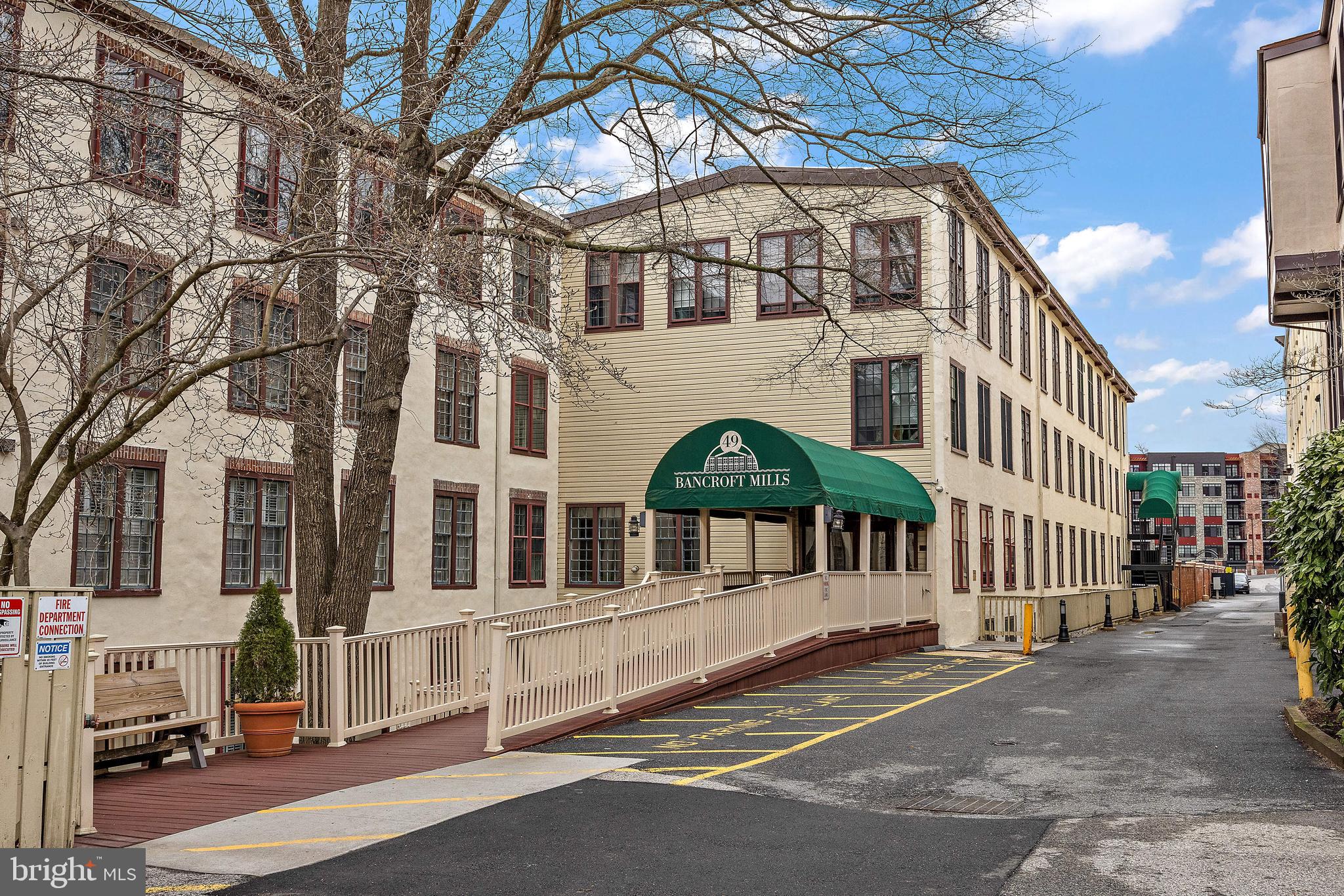 49 Bancroft Mills Road, Unit 2B Wilmington, DE 19806 - Photo 17 of 18 a front view of a building with a street