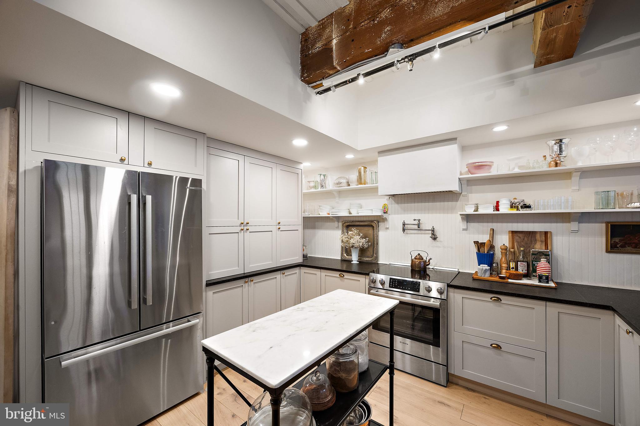 49 Bancroft Mills Road, Unit 2B Wilmington, DE 19806 - Photo 5 of 18 a kitchen with refrigerator and cabinets