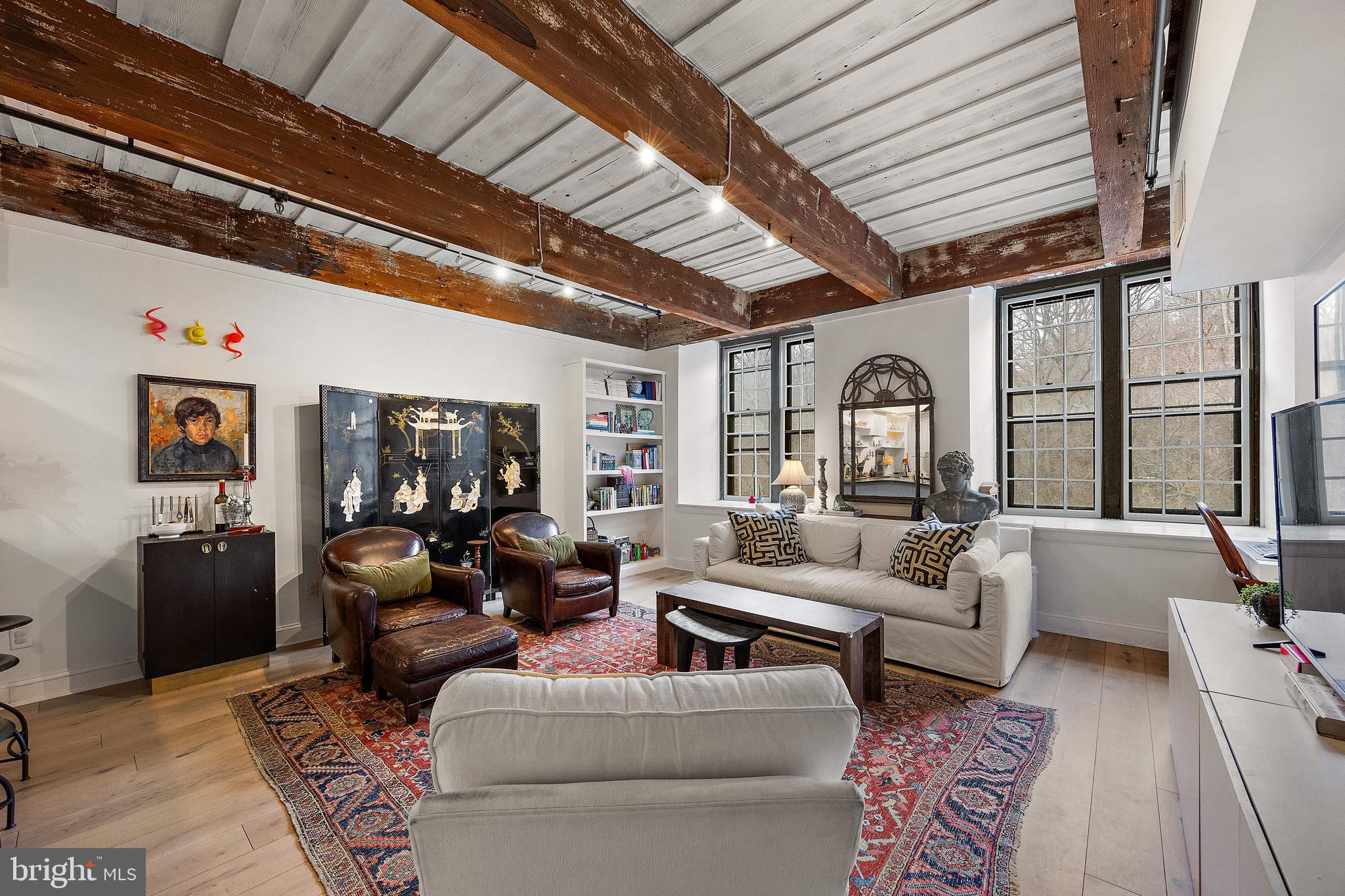 49 Bancroft Mills Road, Unit 2B Wilmington, DE 19806 - Photo 7 of 18 a living room with furniture ceiling fan and a rug