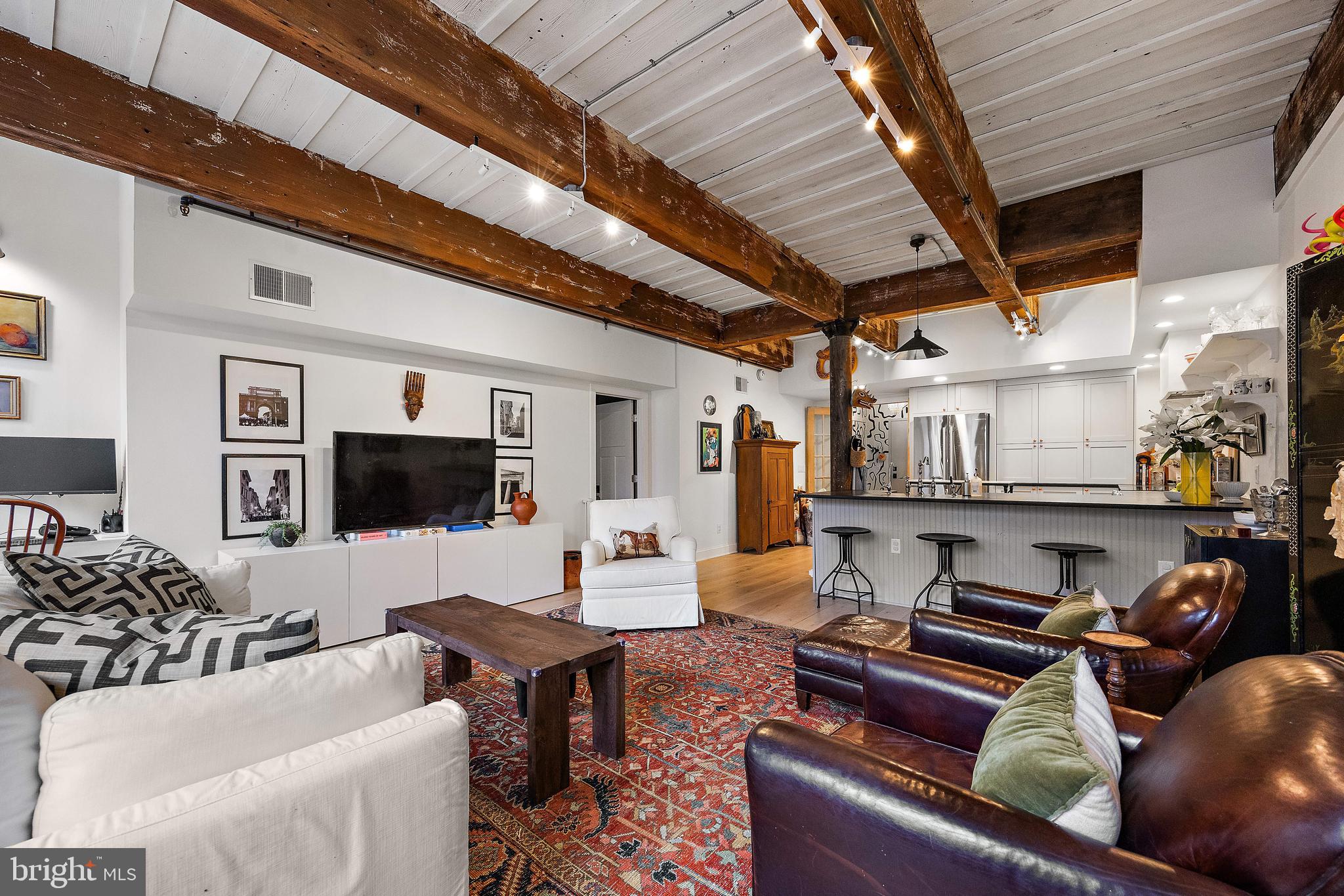 49 Bancroft Mills Road, Unit 2B Wilmington, DE 19806 - Photo 9 of 18 a living room with furniture and a flat screen tv