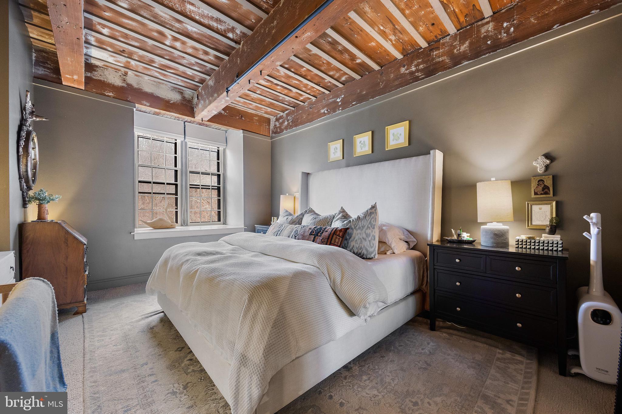 49 Bancroft Mills Road, Unit 2B Wilmington, DE 19806 - Photo 10 of 18 a bed room with a bed and a television