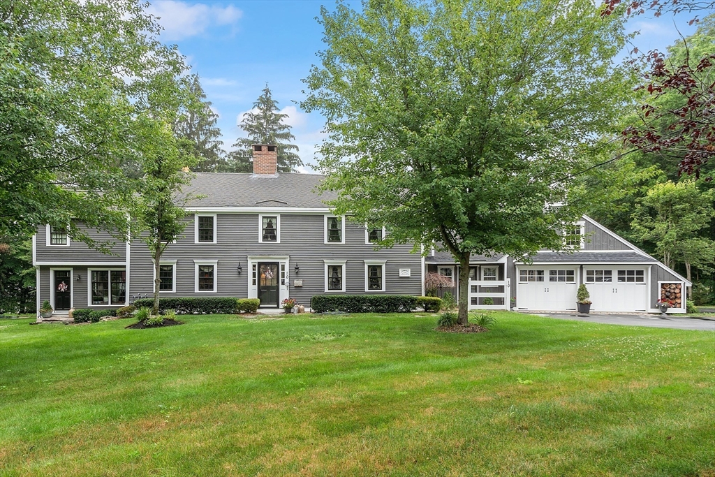 10 Garrison Street Groveland, MA 01834 - Photo 1 of 42 a front view of a house with a yard table and chairs
