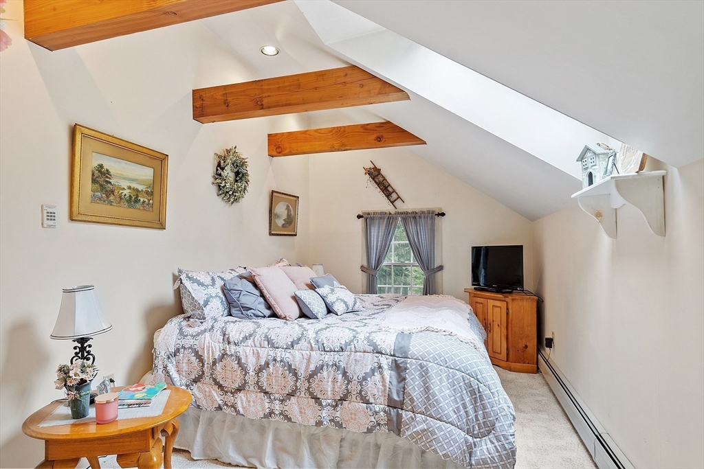10 Garrison Street Groveland, MA 01834 - Photo 22 of 42 a bedroom with a bed and a flat screen tv