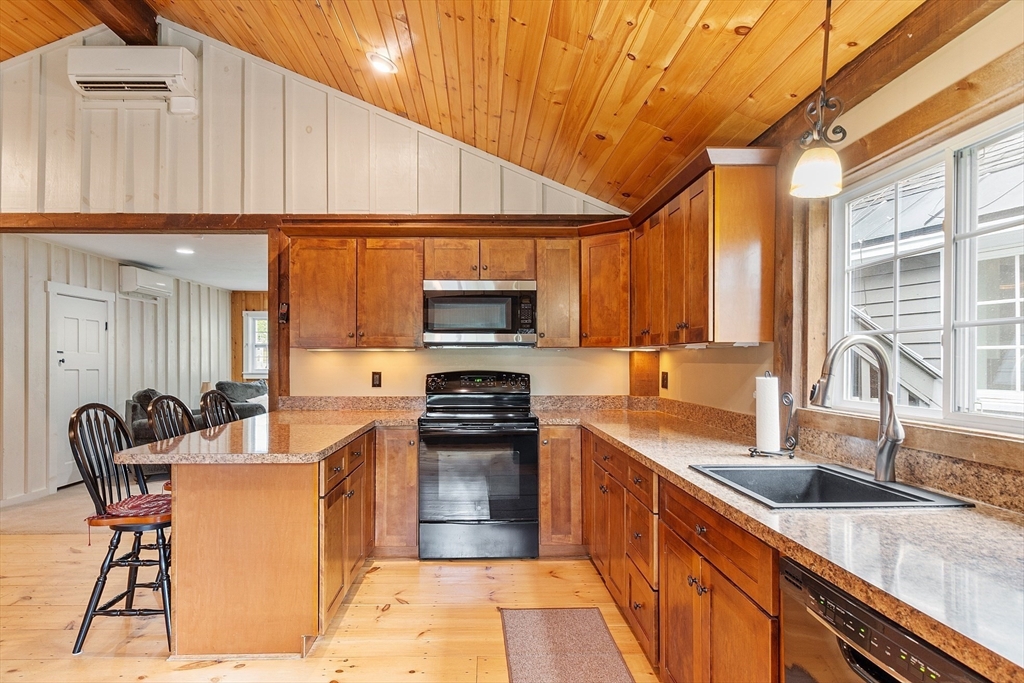 10 Garrison Street Groveland, MA 01834 - Photo 30 of 42 a kitchen with stainless steel appliances a sink a counter top space cabinets and a window